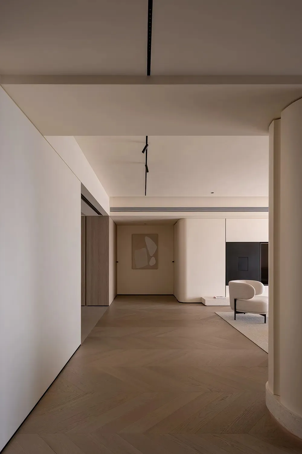 A modern living space featuring wooden floors and minimalist design elements.