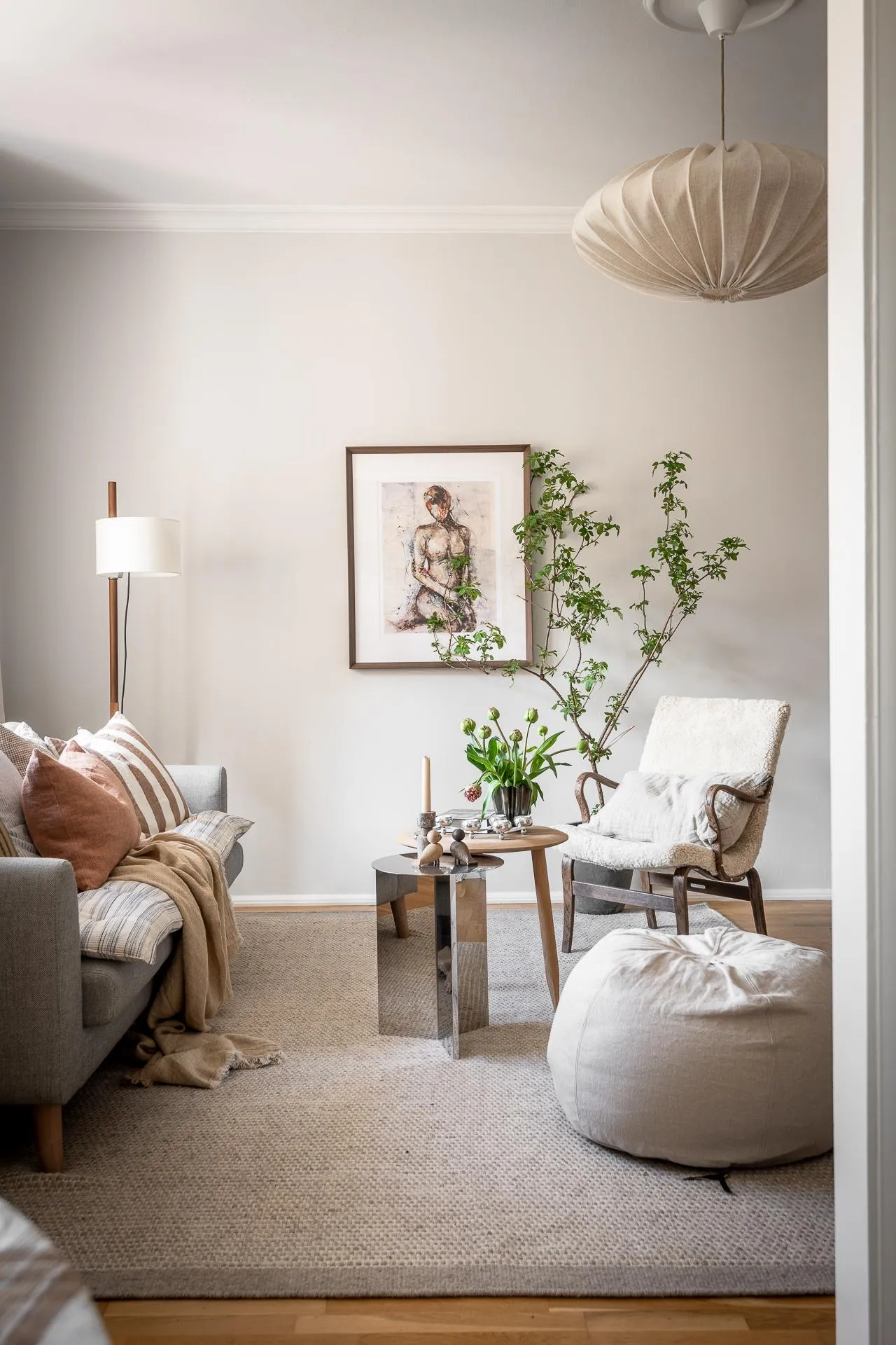 A modern living room with taupe furniture, a minimalist design, and natural light.