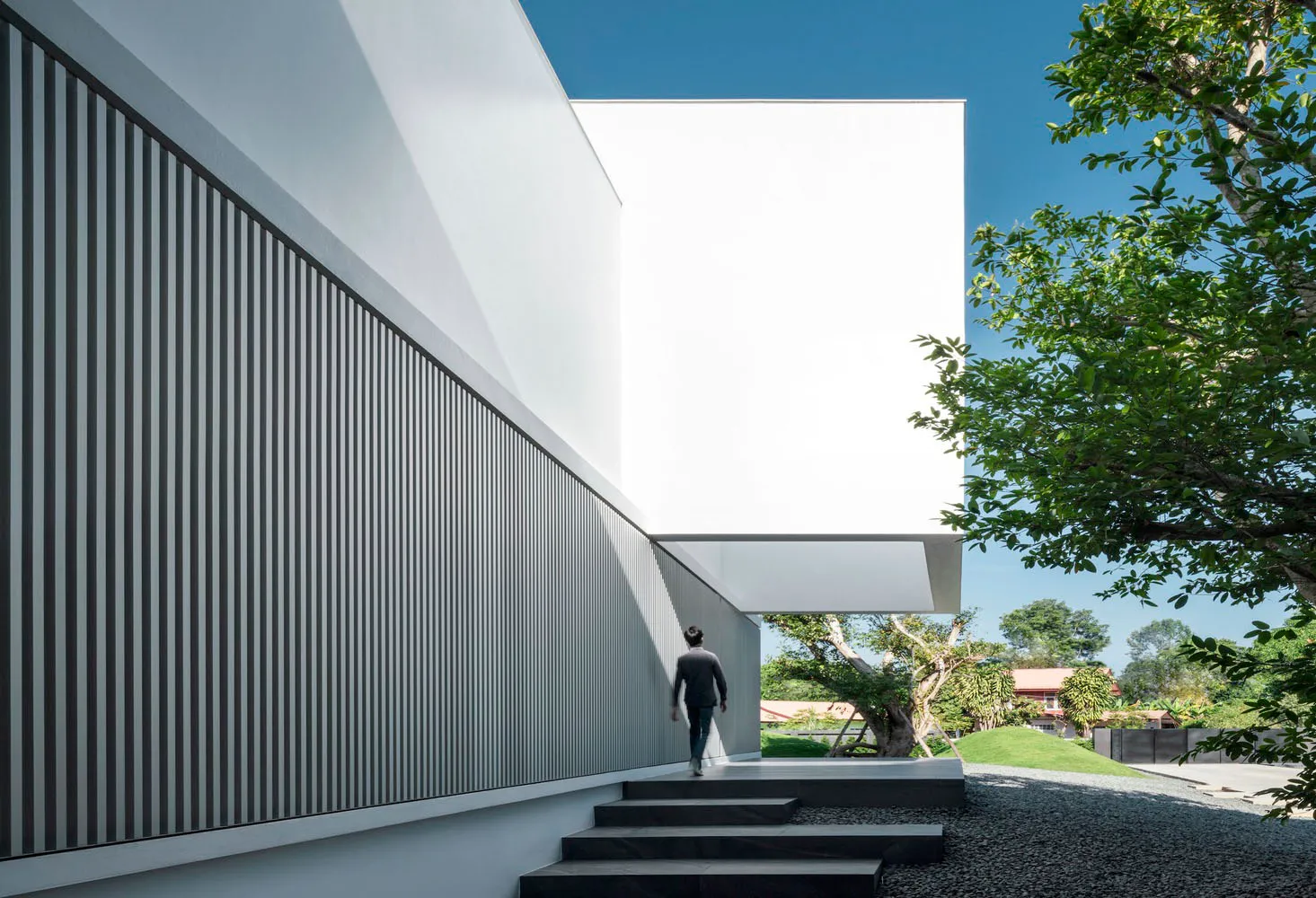 A modern exterior space featuring a minimalist design with concrete materials.