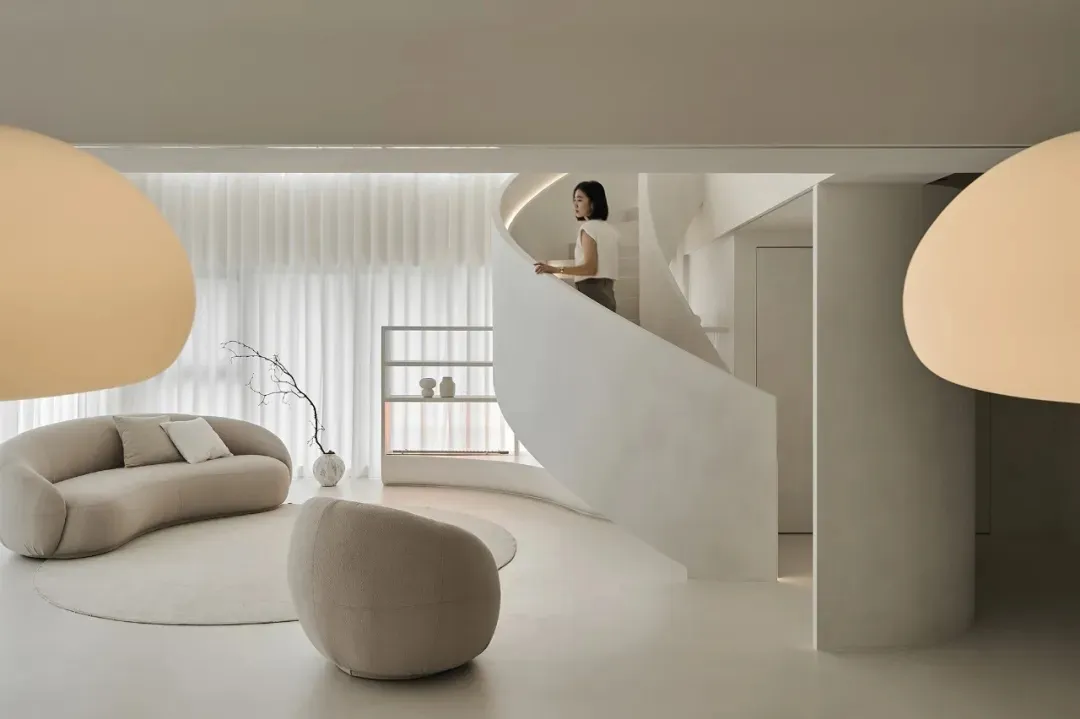 A modern living room featuring neutral-toned furniture and decor in a minimalist design style.
