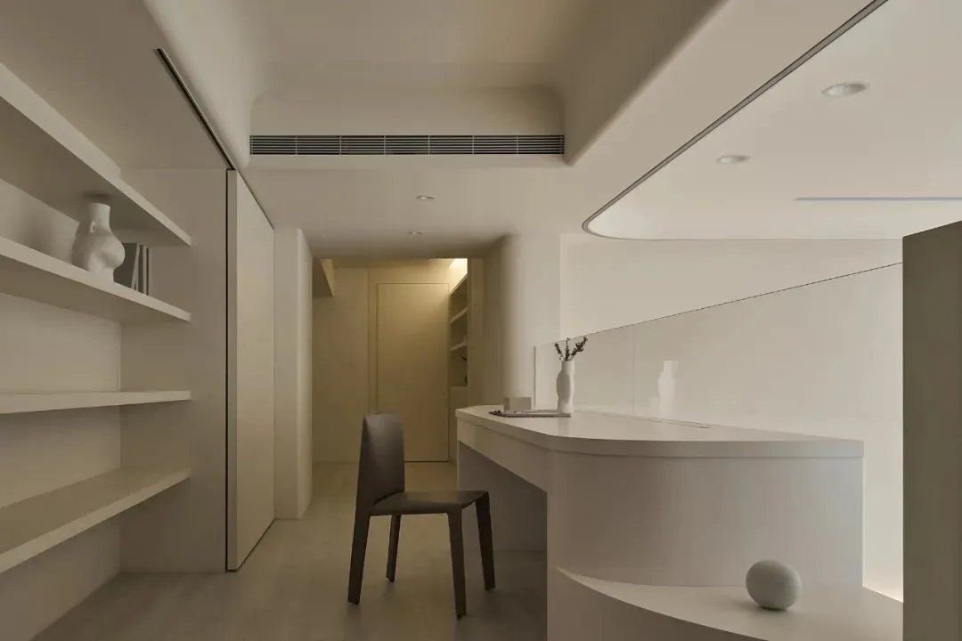 A modern office space with white surfaces, minimal decor, and a sleek, contemporary design.