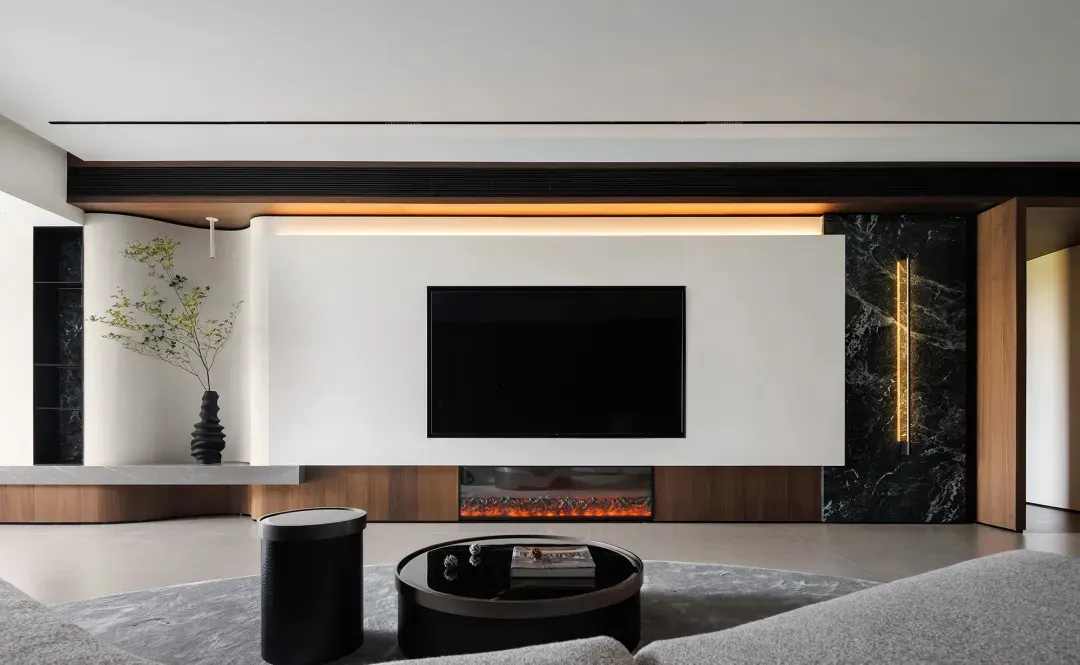 A modern living room with marble tiles, wooden accents, and concrete flooring.
