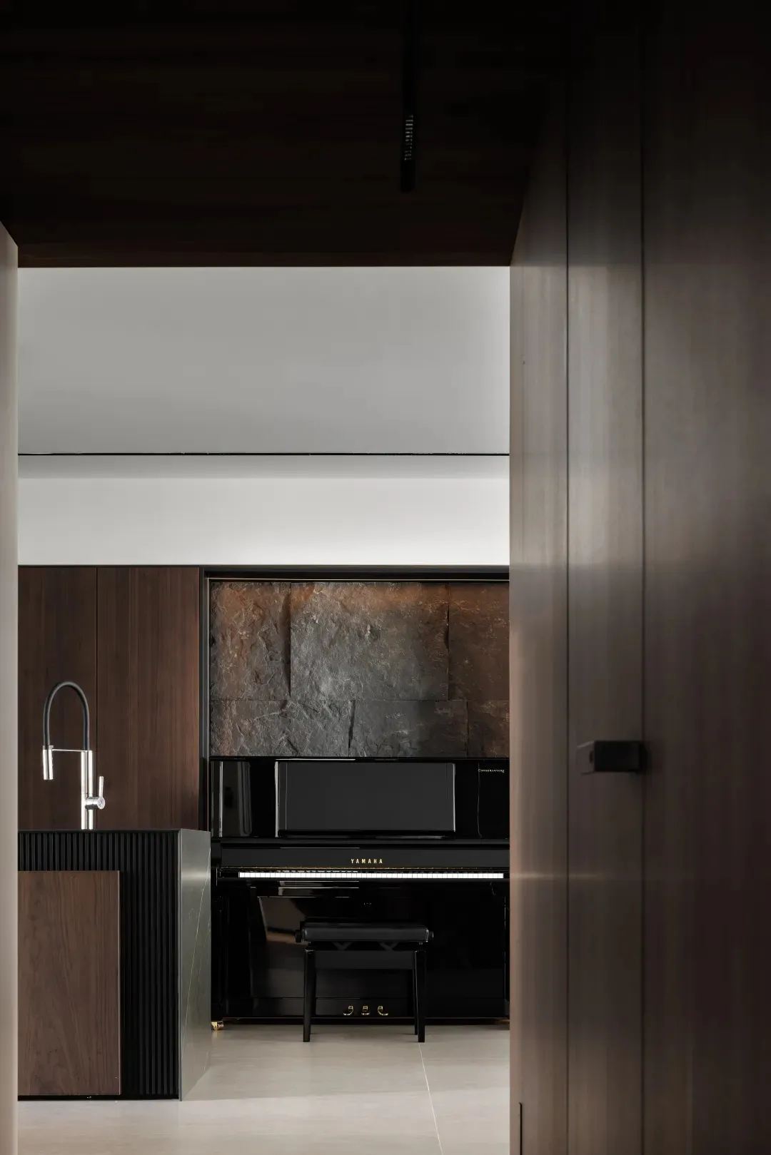 A modern interior space featuring minimalist design with wood and metal materials.