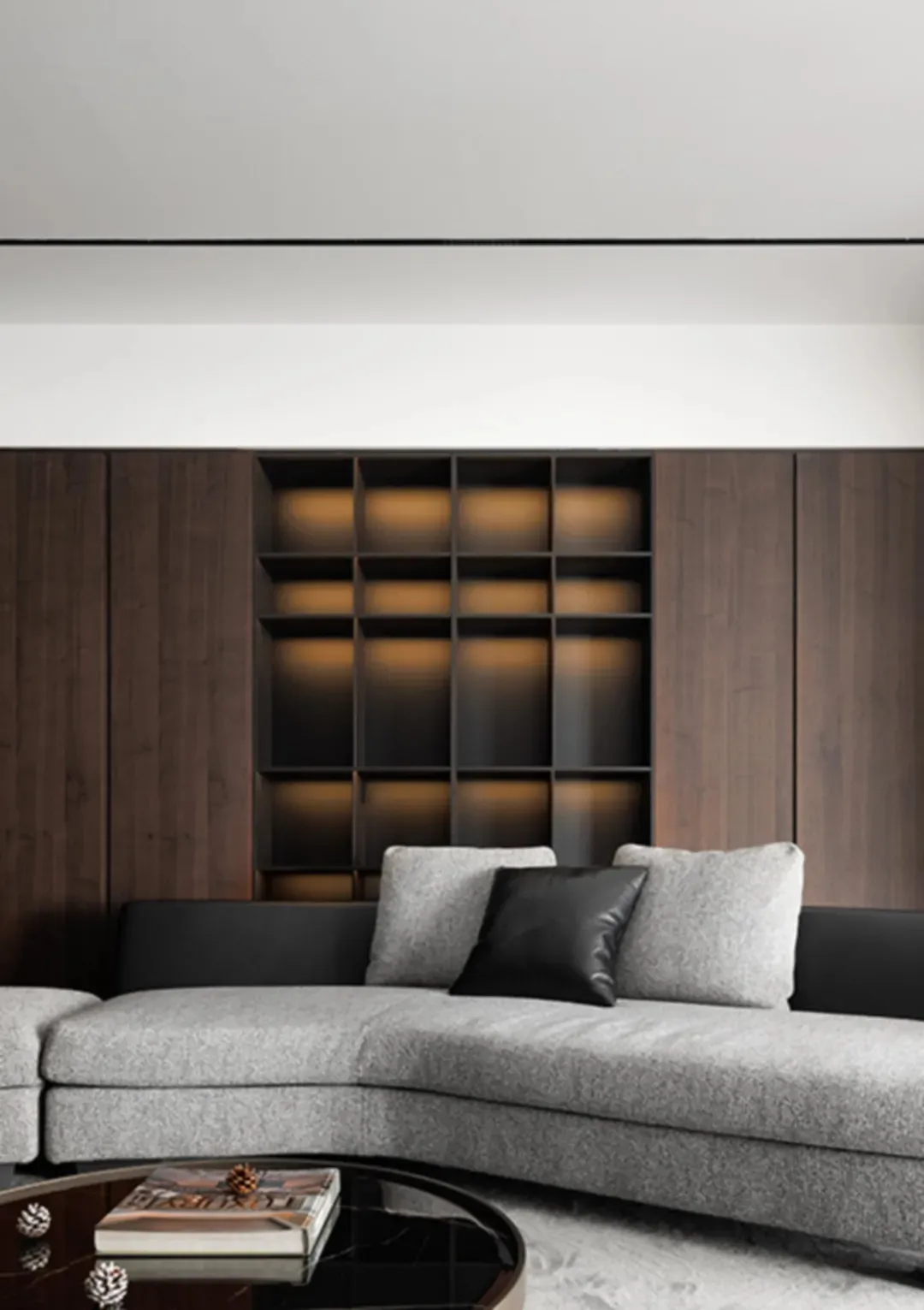 Modern living room with wooden paneled backdrop, featuring a cozy arrangement of contemporary furniture and lighting.