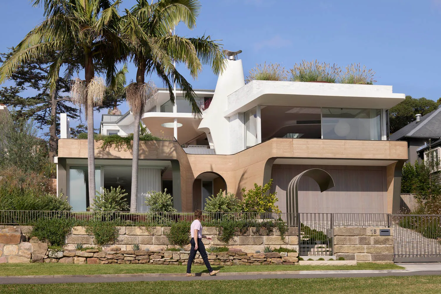 A modern residential architecture featuring concrete, metal, and glass materials.