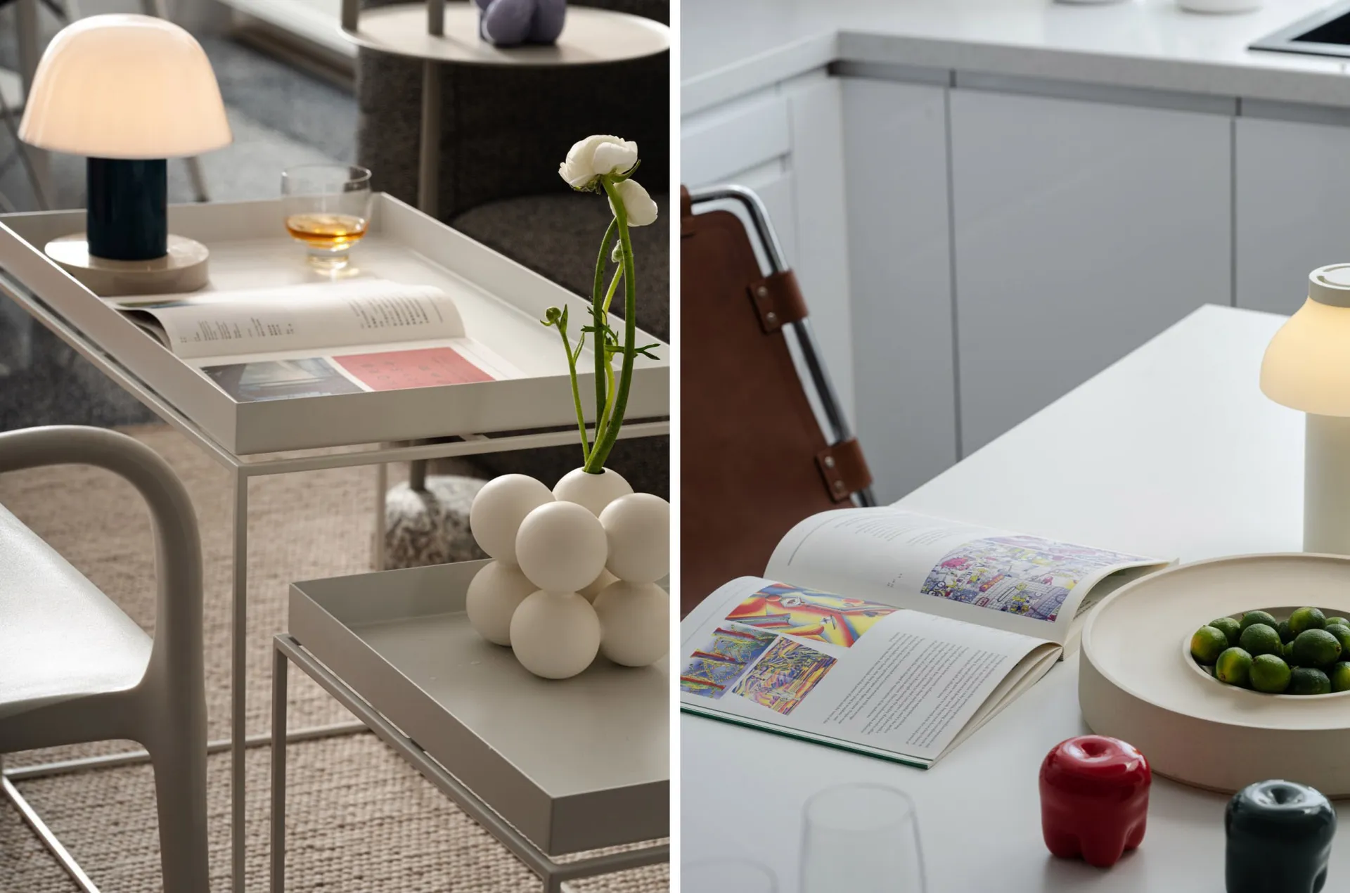 A modern kitchen with minimalist design, featuring white countertops and a white table with a vase of flowers and a book.