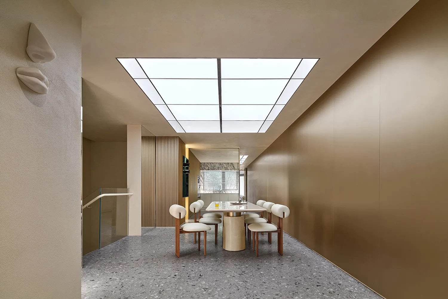 Contemporary dining room with modern minimalist style, featuring a rectangular table and white chairs under a skylight ceilin