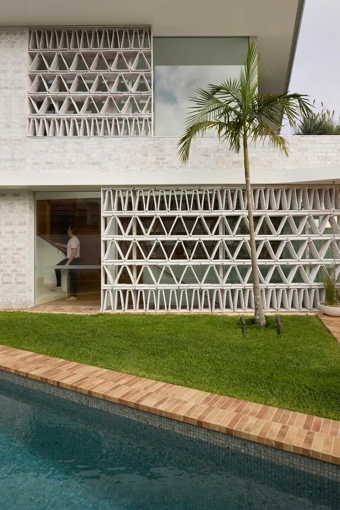 Modern residential exterior with brick and glass materials.