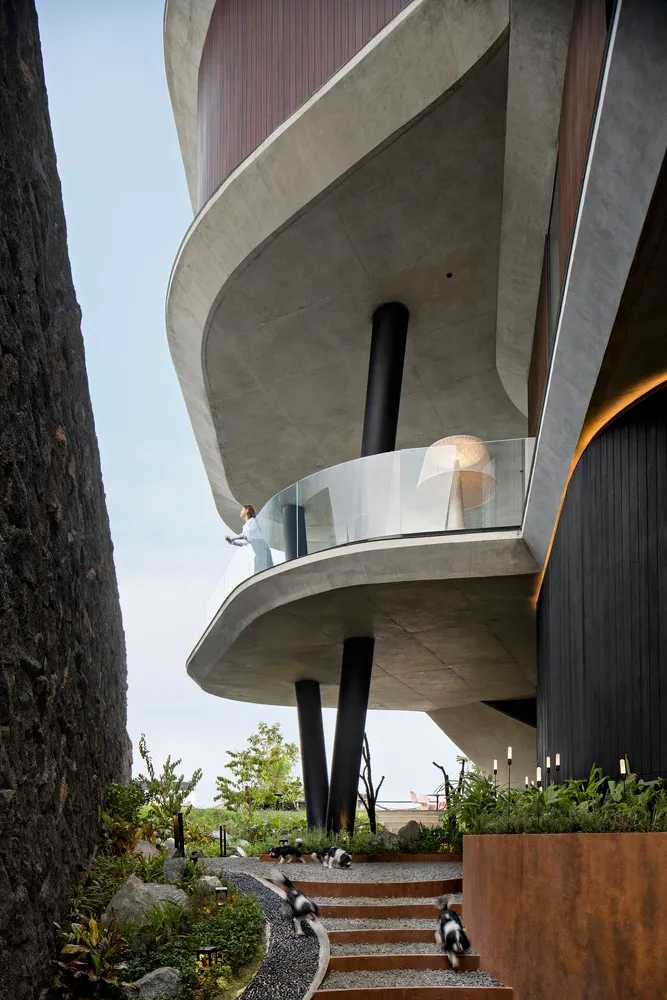 Modern residential exterior featuring concrete and glass materials.