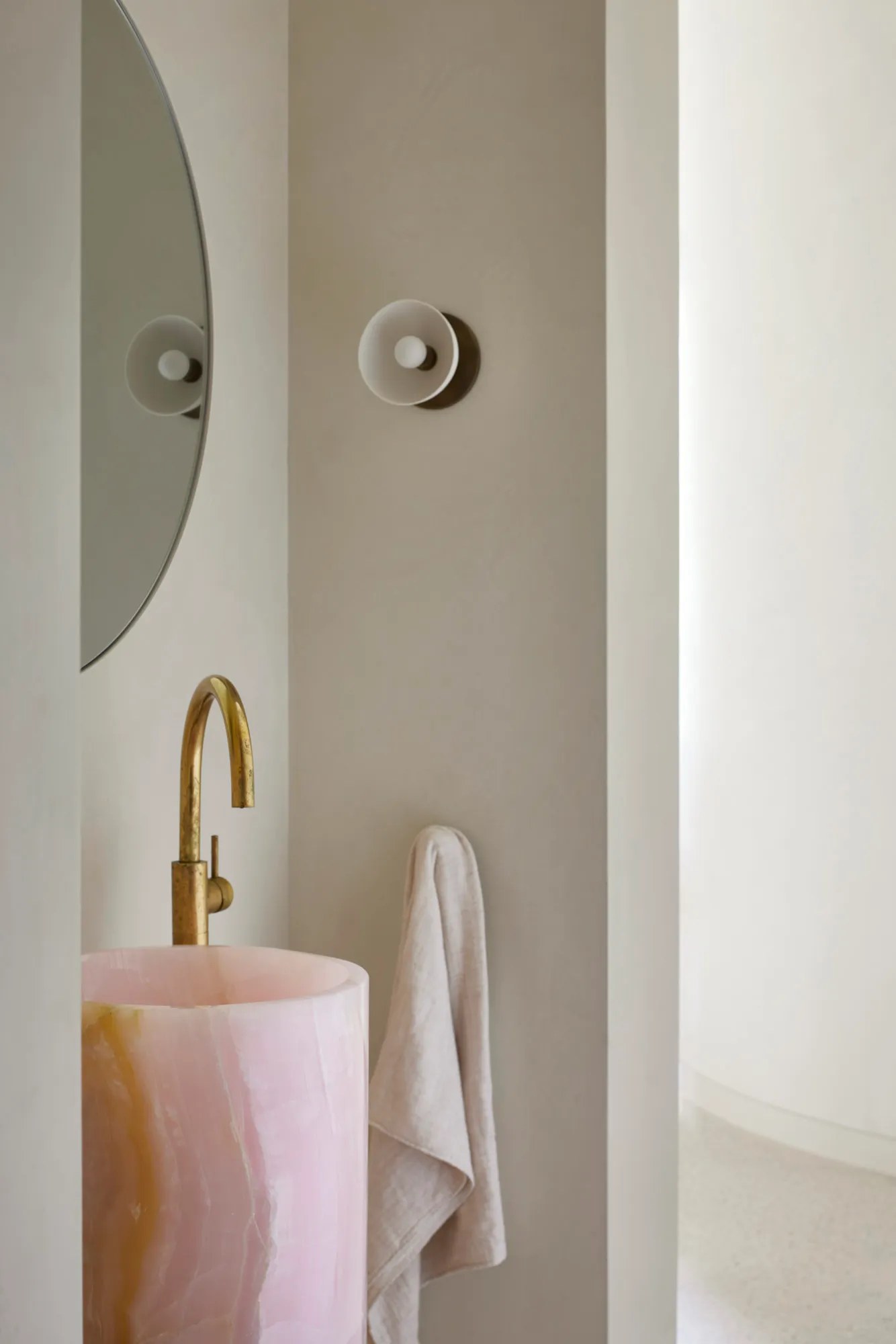 A minimalist interior design featuring a marble sink and faucet.