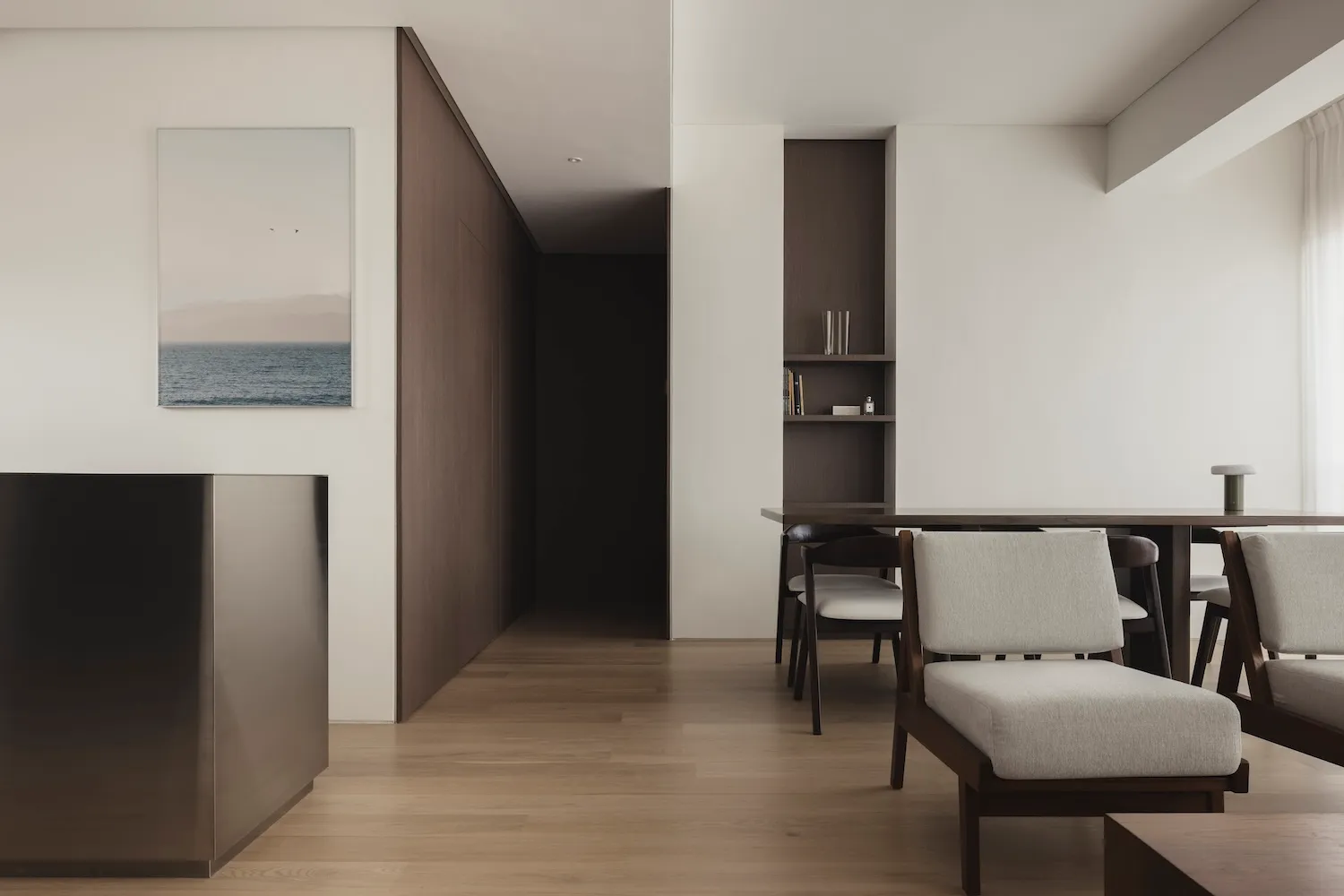 Modern minimalist living room with wooden furniture, fabric upholstery, and metal accents.