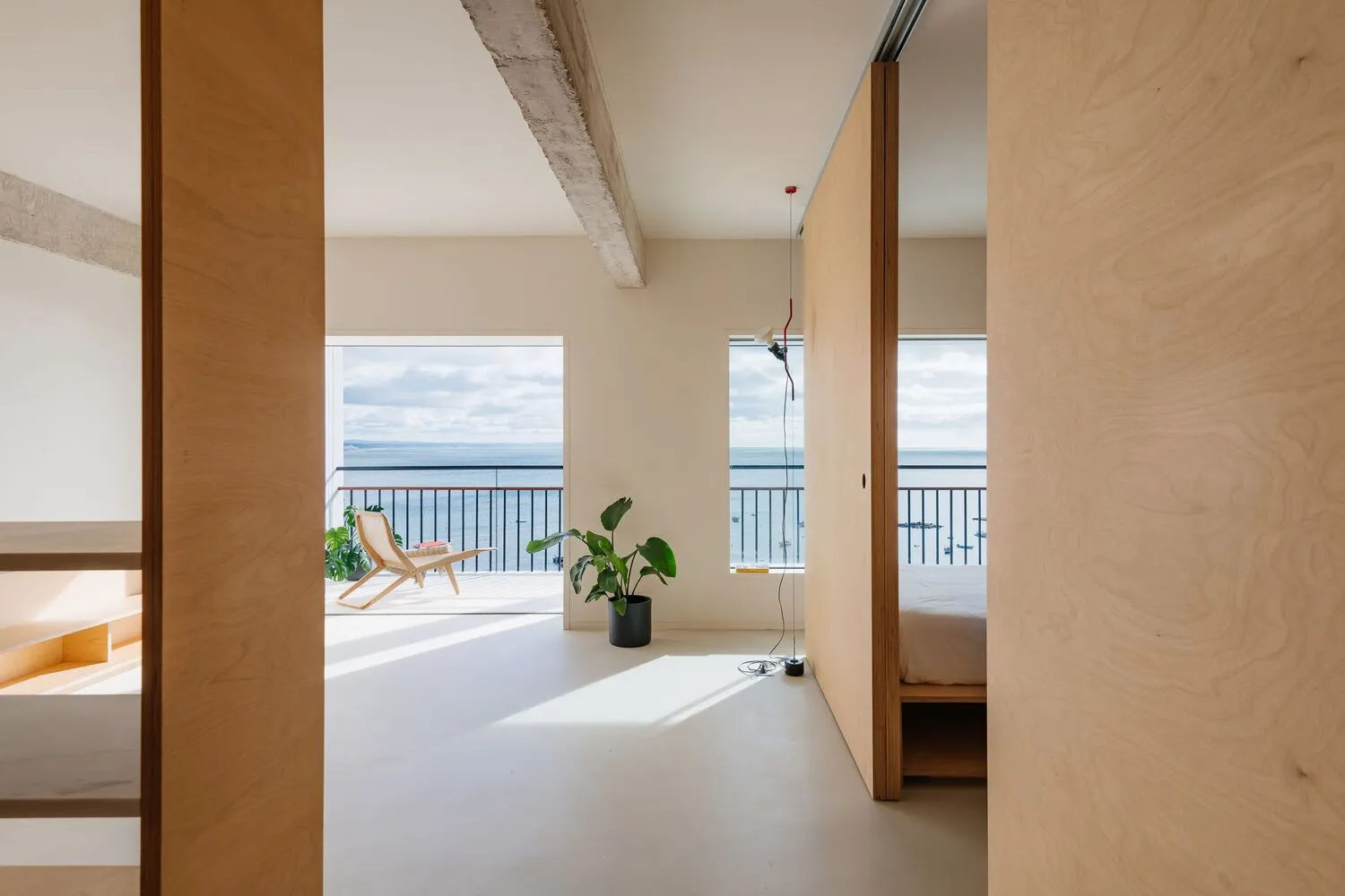 A minimalist residential space featuring wood and concrete materials.