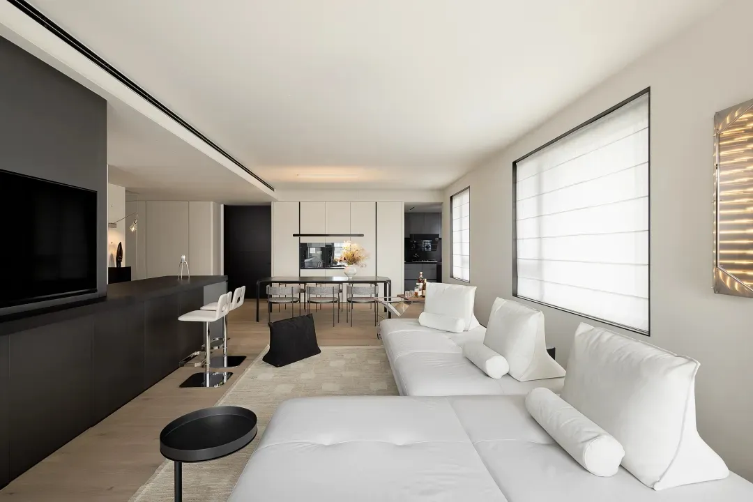 A minimalist living room with neutral color schemes and furniture.
