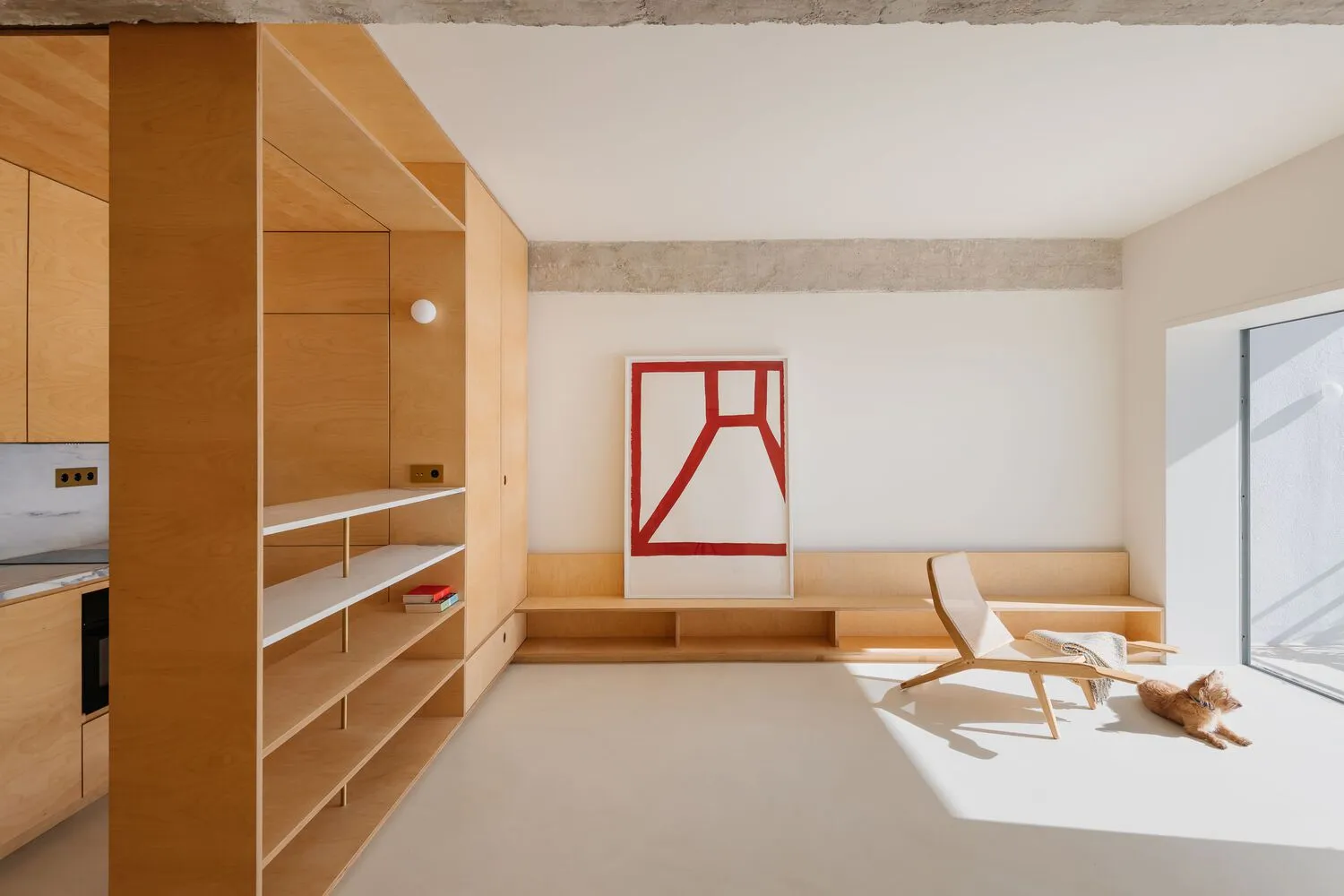 A minimalist living area with a wooden feature wall and a geometric art piece.