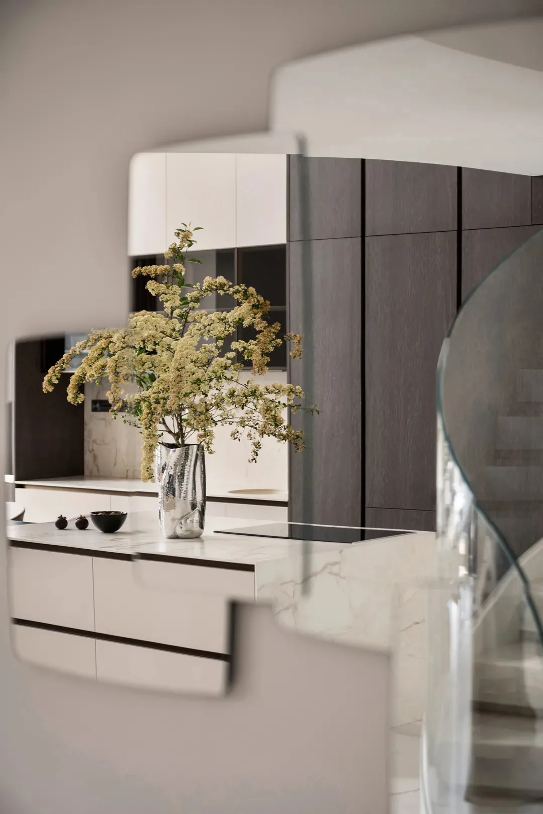 Modern kitchen with marble countertops and white cabinets