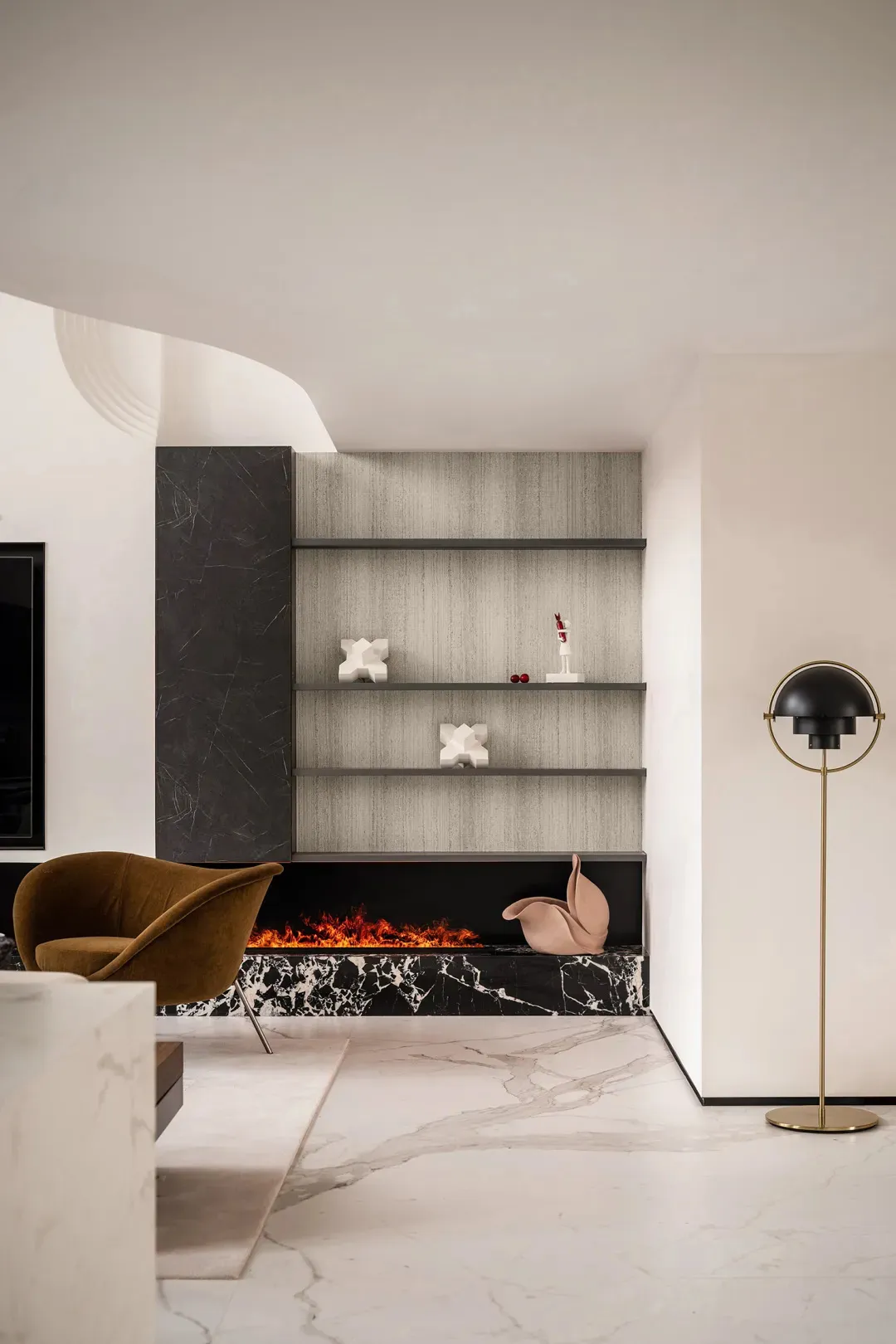Modern living room featuring a marble fireplace with a warm fire burning.