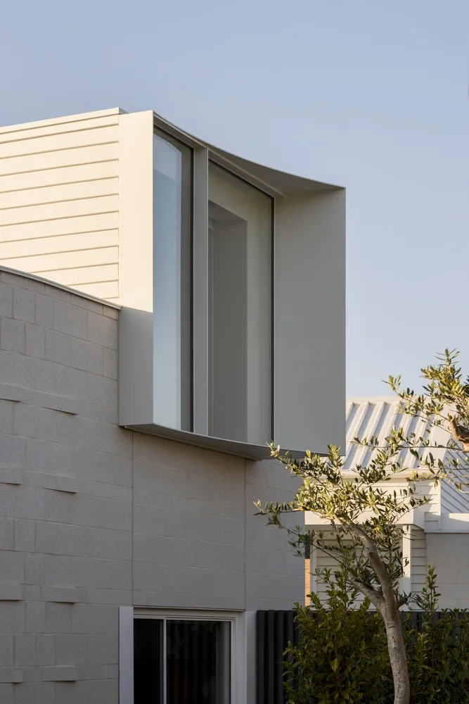 Modern building with concrete exterior and large window.