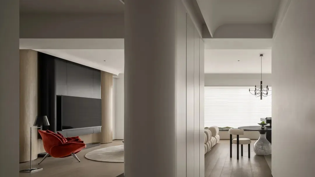 Modern living room with wood floors, metallic fixtures, and contemporary furniture.