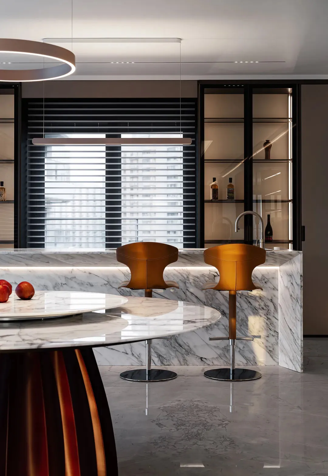 A modern kitchen features marble countertops and a sleek, contemporary design.