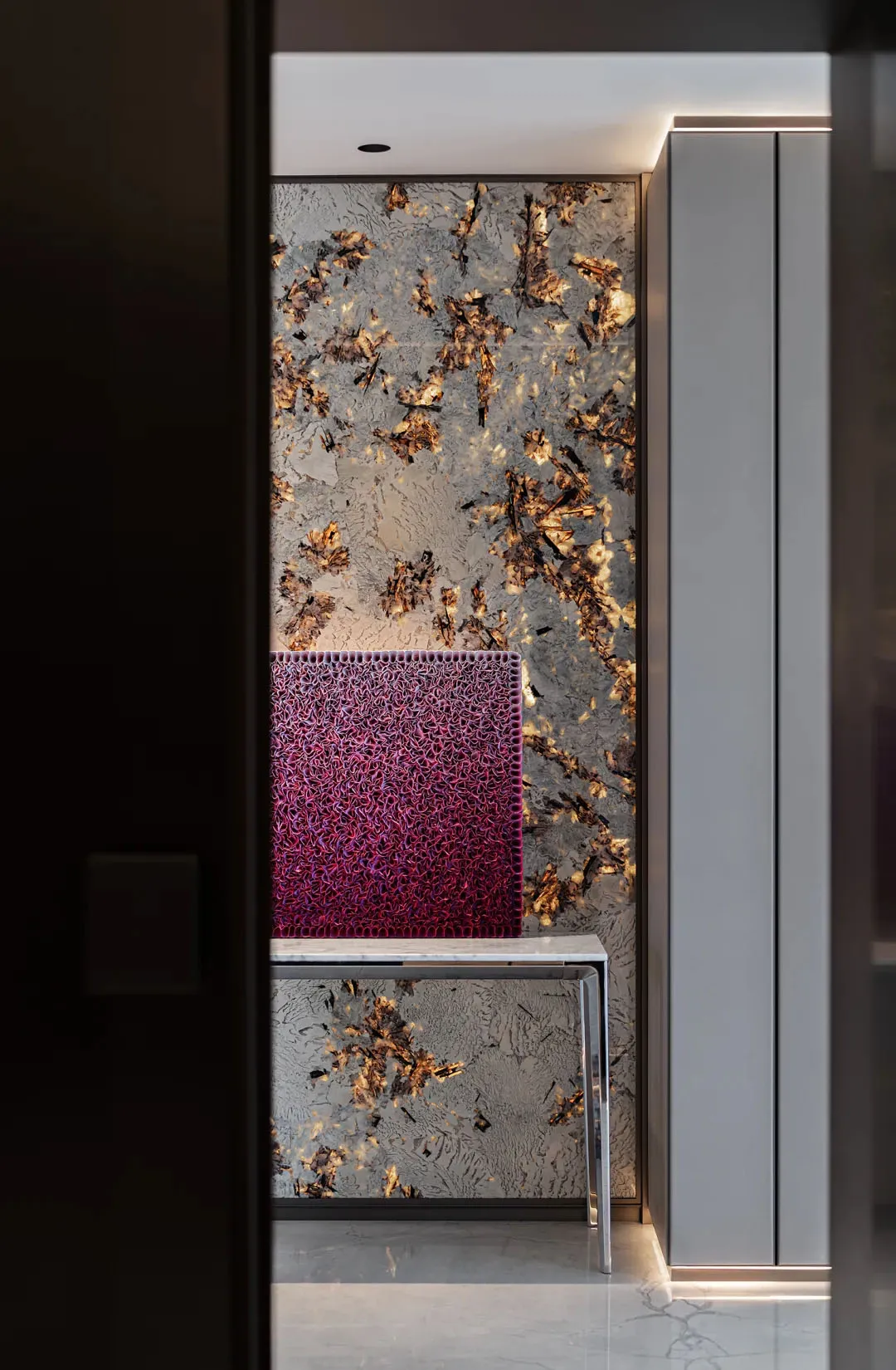 Modern, minimalist lobby with concrete, metal, and glass elements.