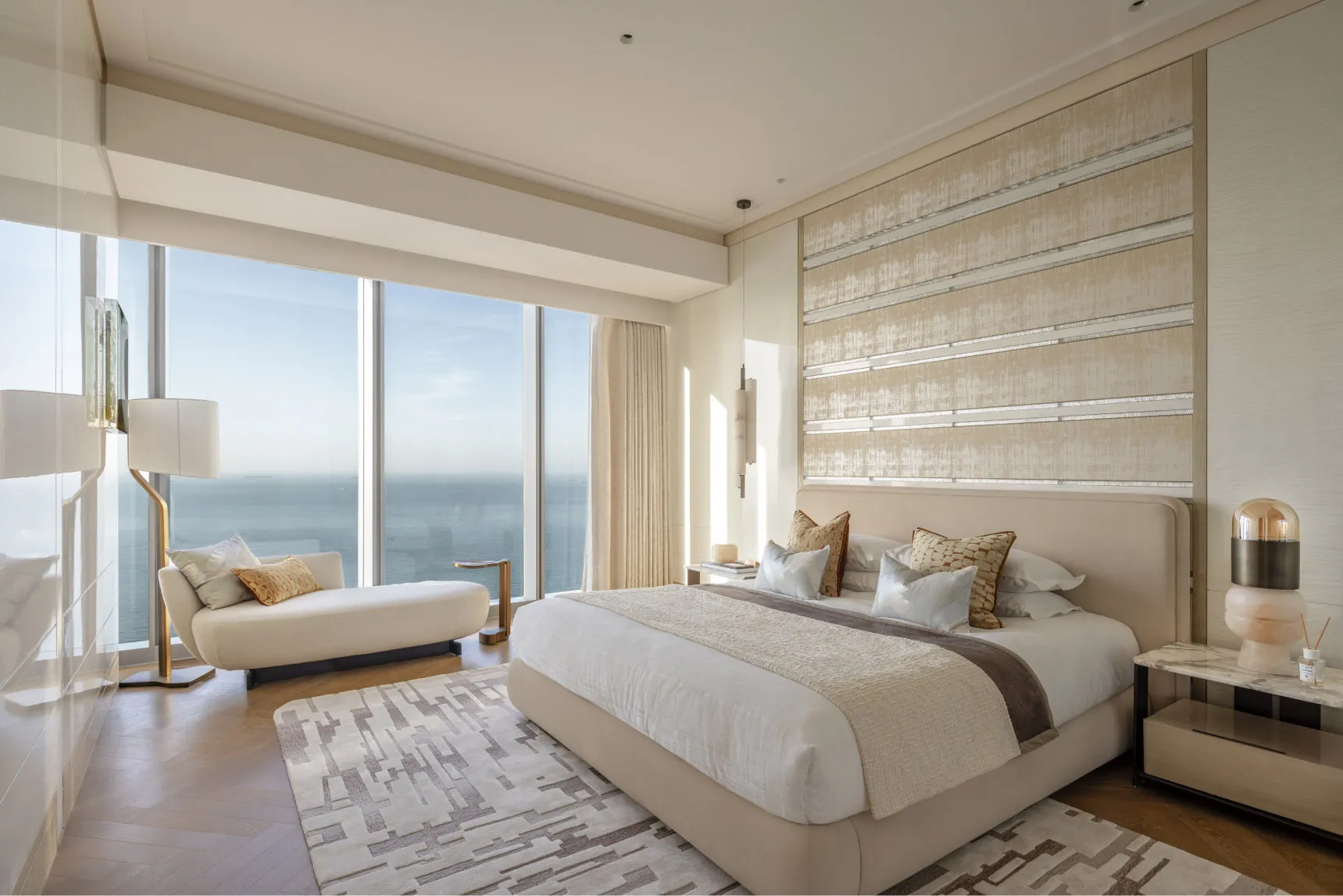Modern minimalist bedroom with fabric bedding, wooden floor, and metal accents.