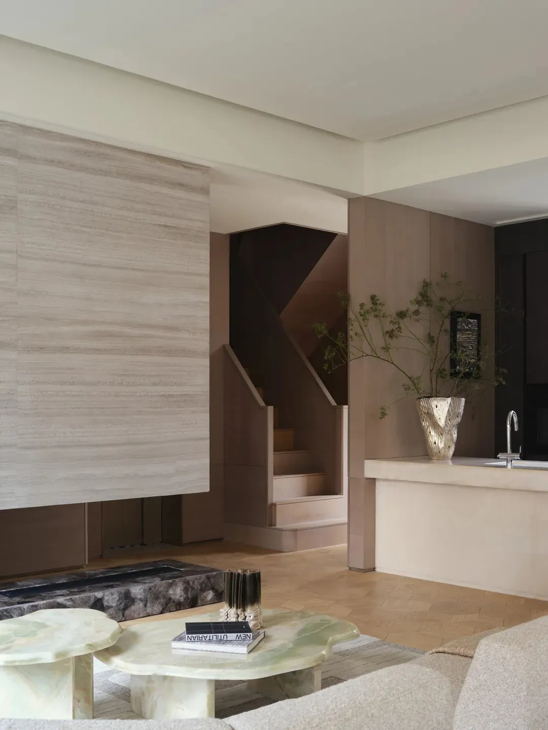 A minimalist living room with concrete walls and furniture.