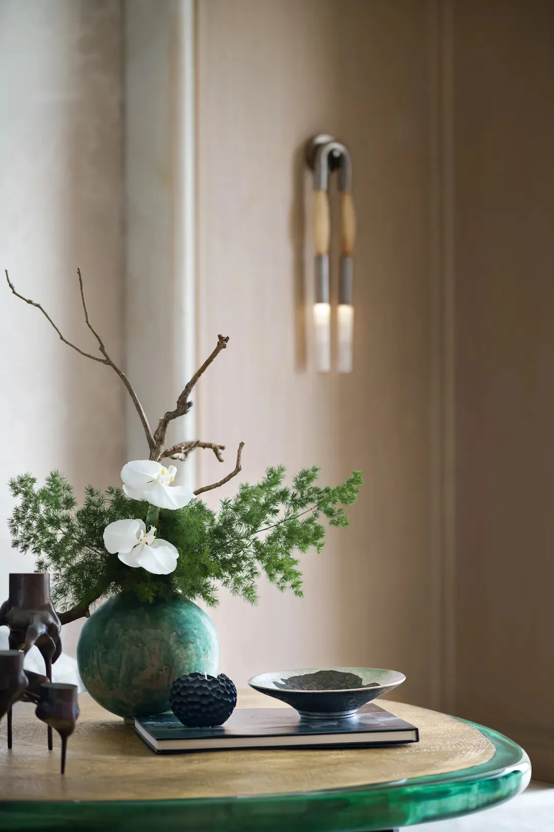 A modern interior design with a ceramic ornament, walnut wood, and steel accents. The scene features a minimalist living room