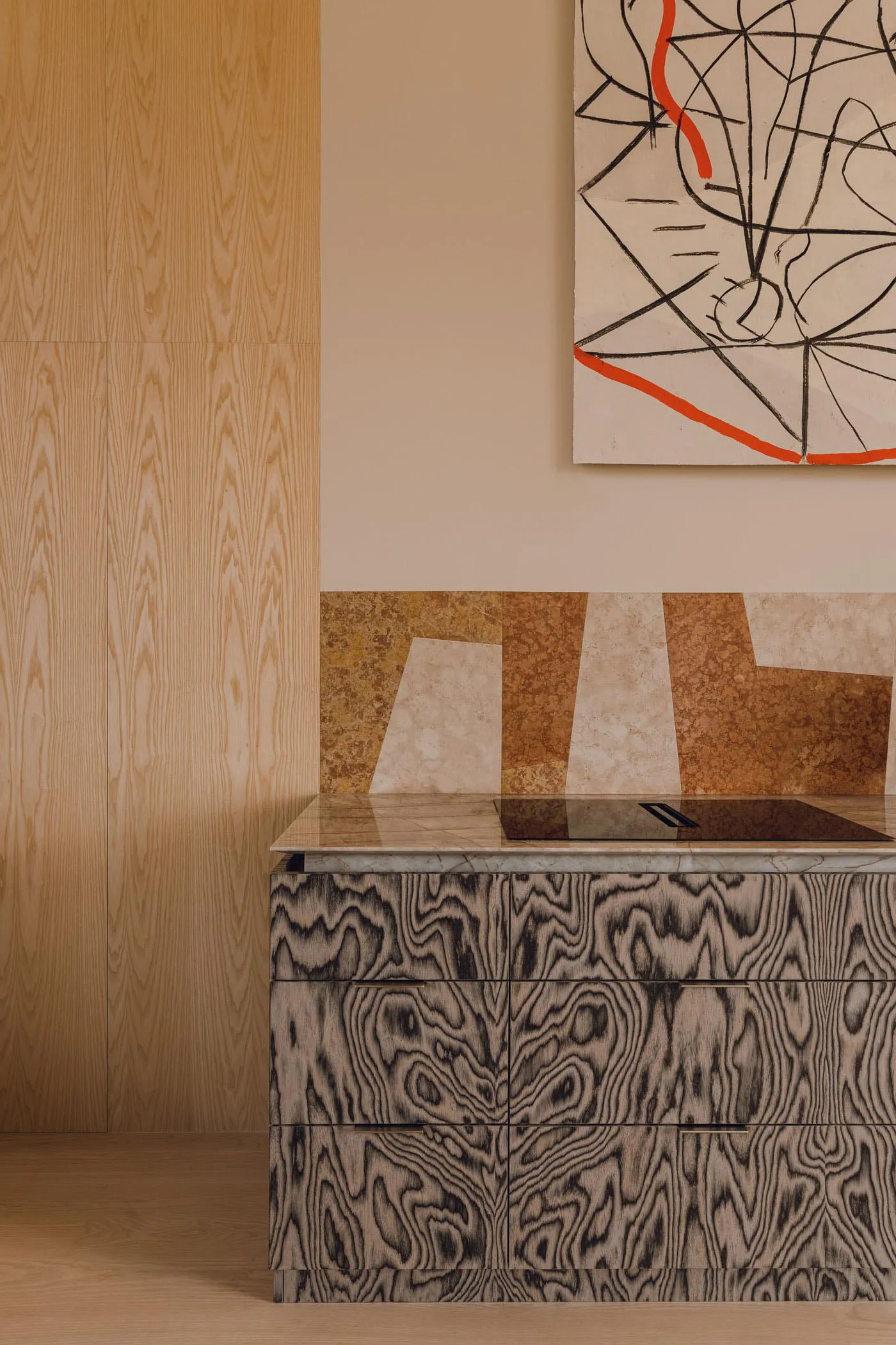 Modern kitchen featuring a marble countertop and wooden cabinets.