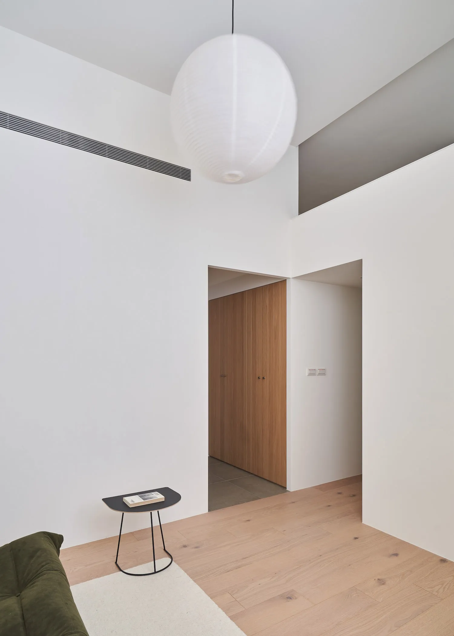 Modern, minimalist living room featuring wood materials and sleek design.