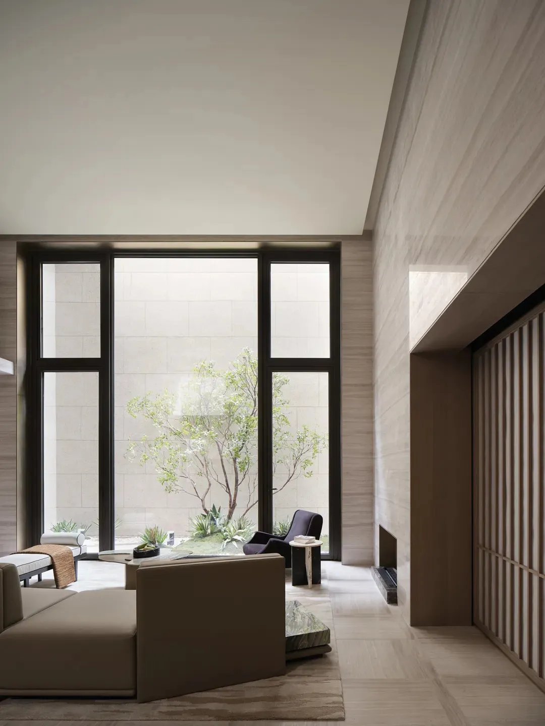 A modern, minimalist living room with neutral-colored furniture, large windows, and a minimalist design.