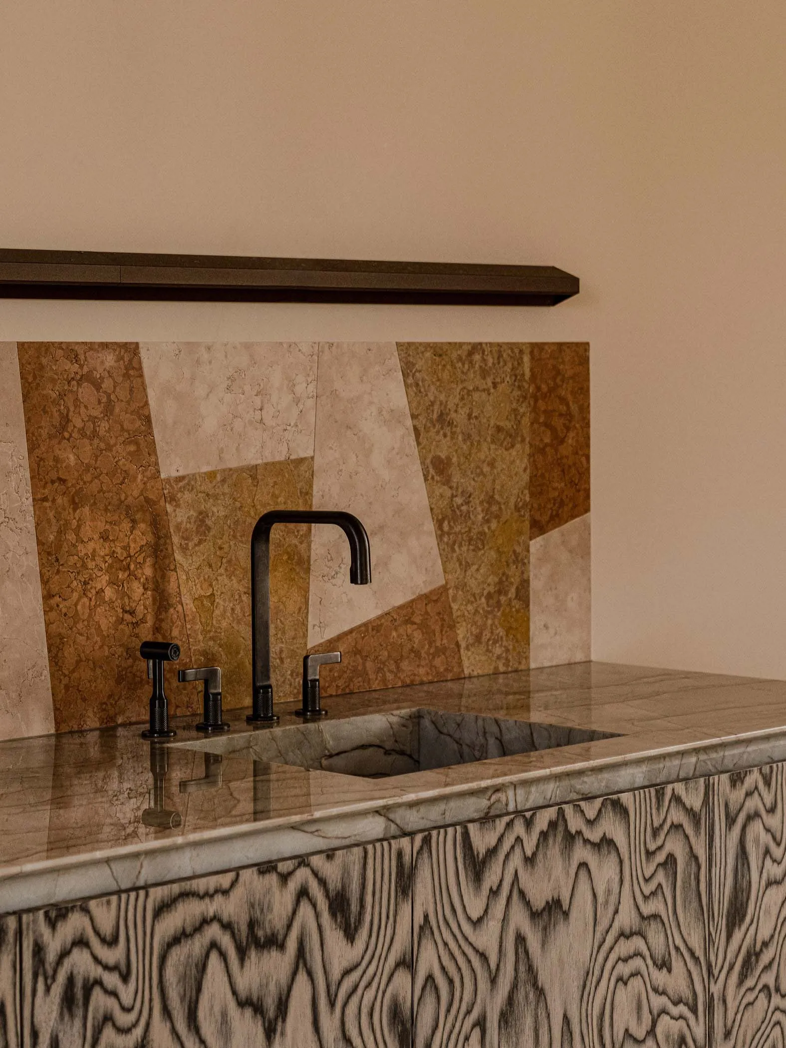 A minimalist kitchen with a marble countertop and sink.