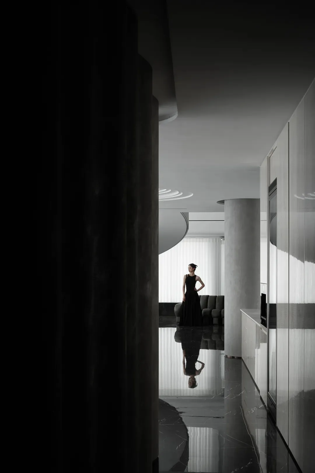 A modern apartment with glass walls and marble finishes.