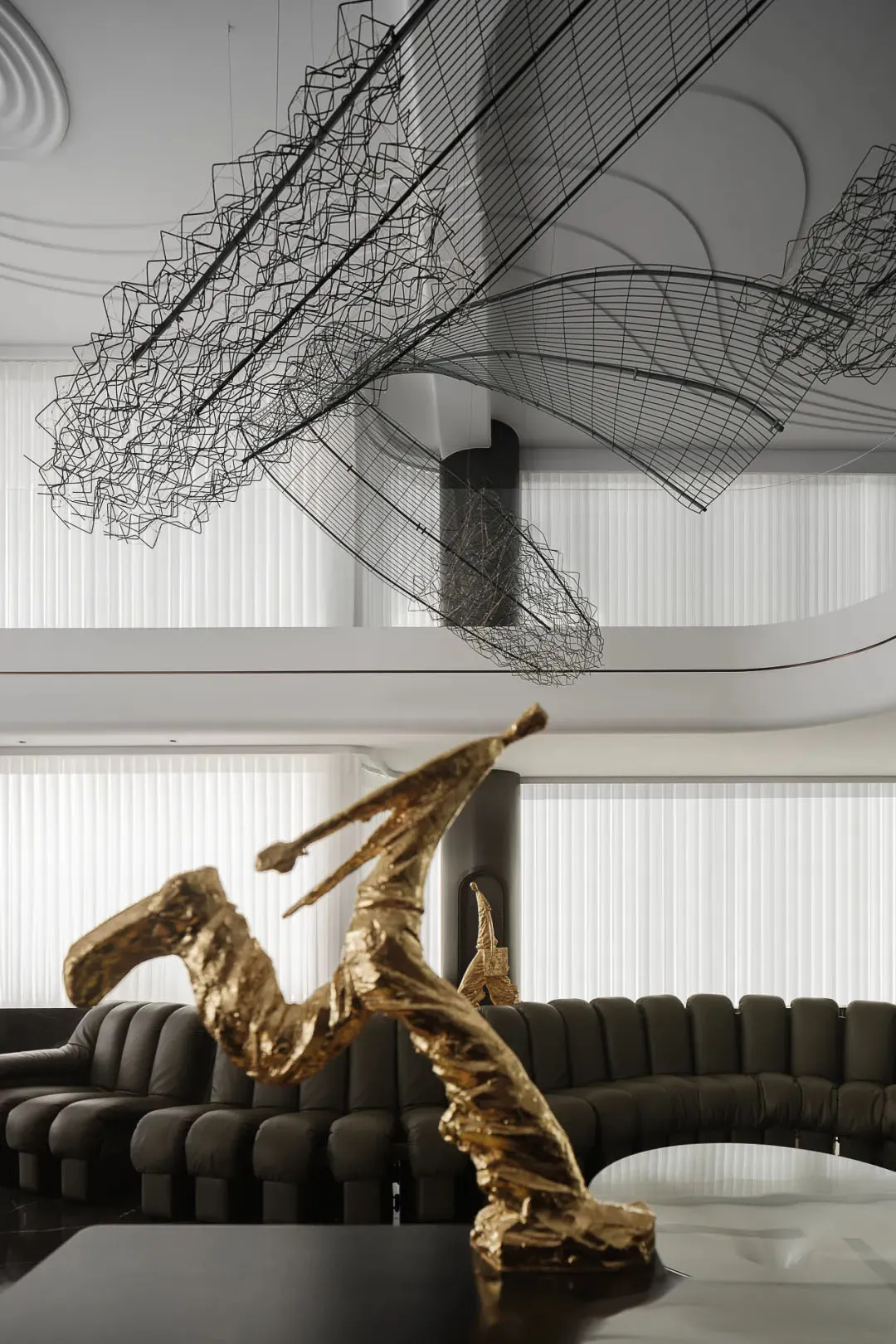 A modern interior design featuring metal wire art installations.