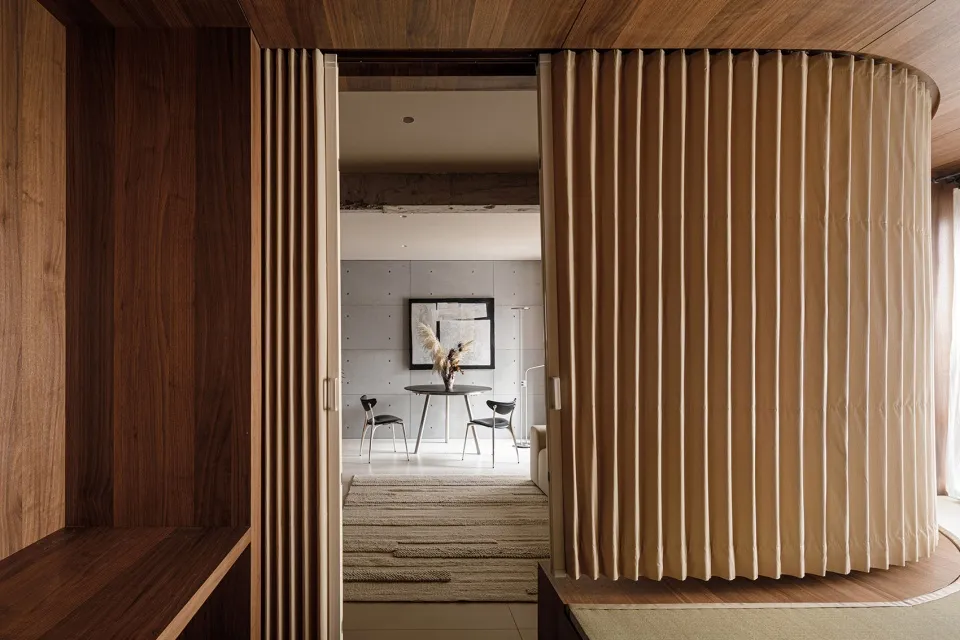 Modern residential interior with wooden curtains and exposed concrete walls
