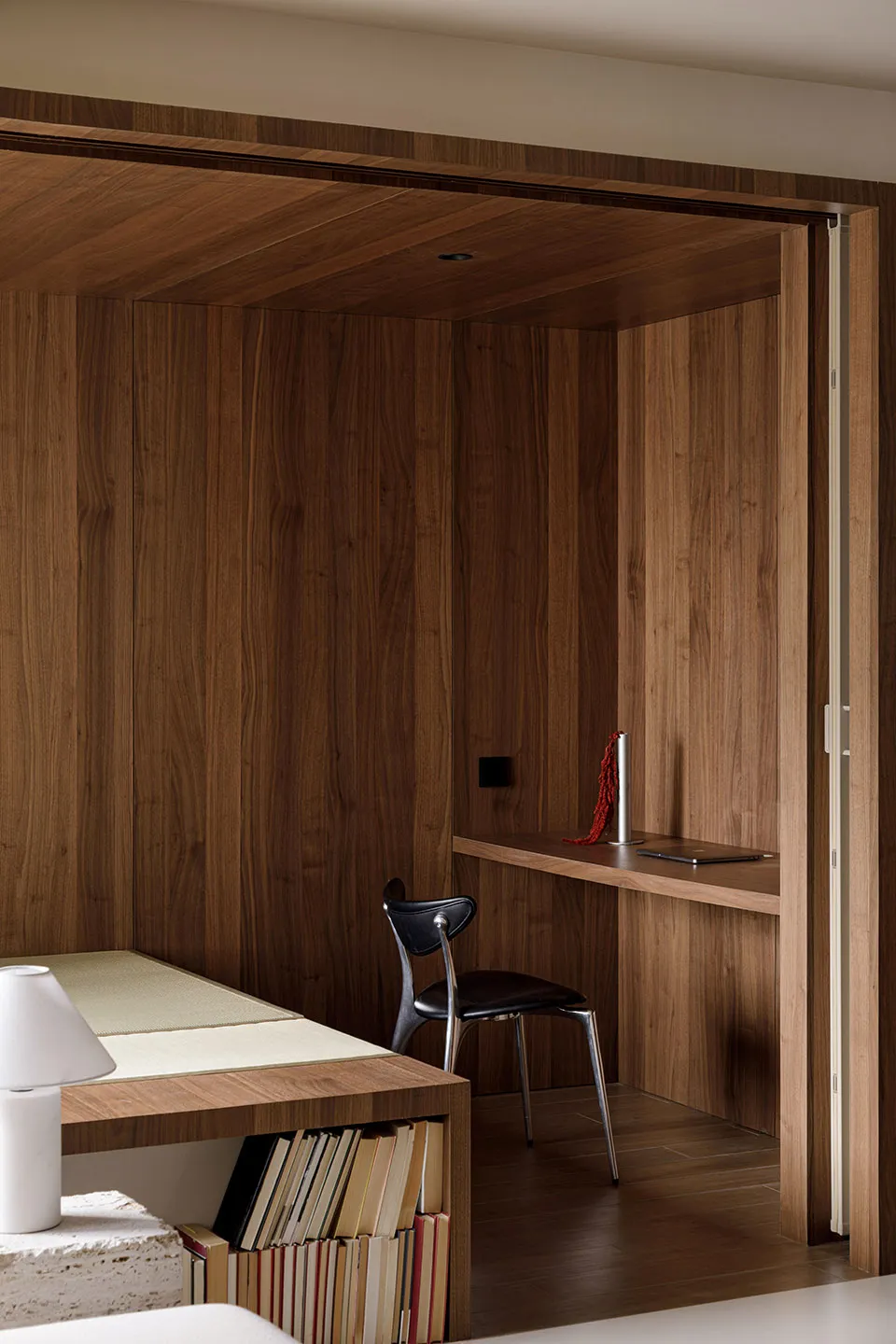 Modern minimalist office space featuring wood paneling and furniture.