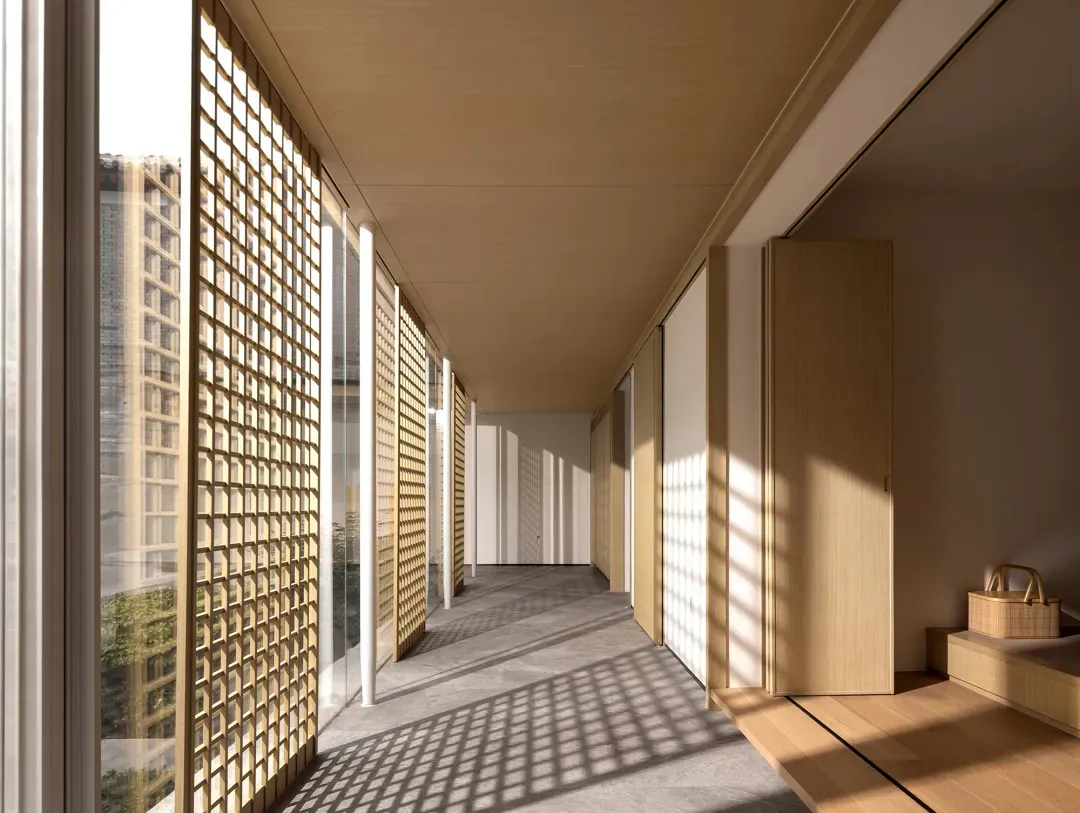 A modern corridor featuring large windows with grid-like patterns, illuminated by natural light.