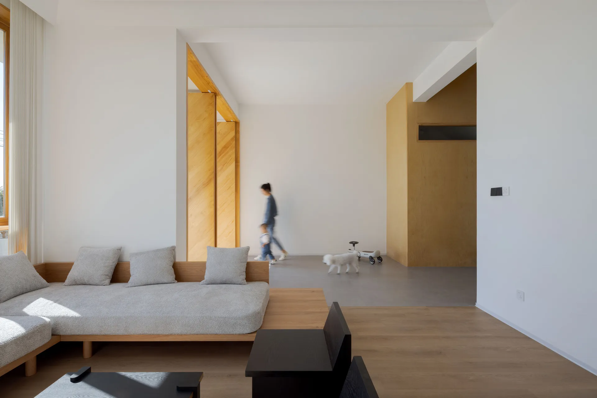 A modern living room with minimalist design and wooden finishes.
