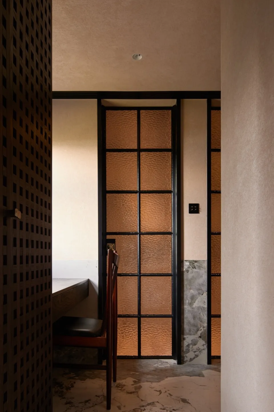 Metallic glass door in a residential interior setting