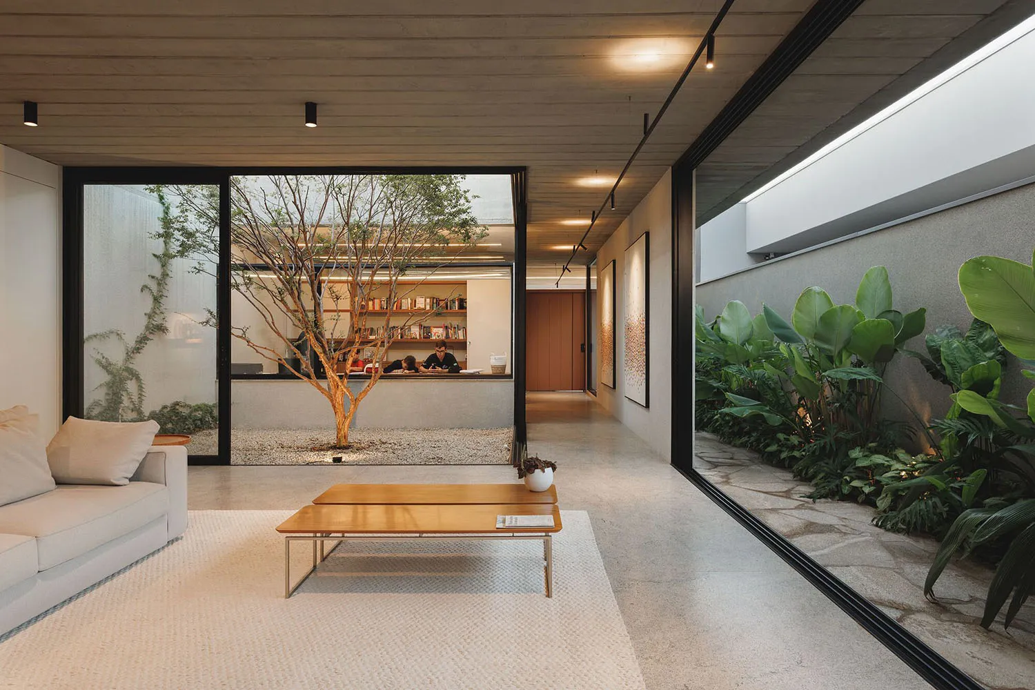 Modern minimalist living room with concrete floor and glass wall