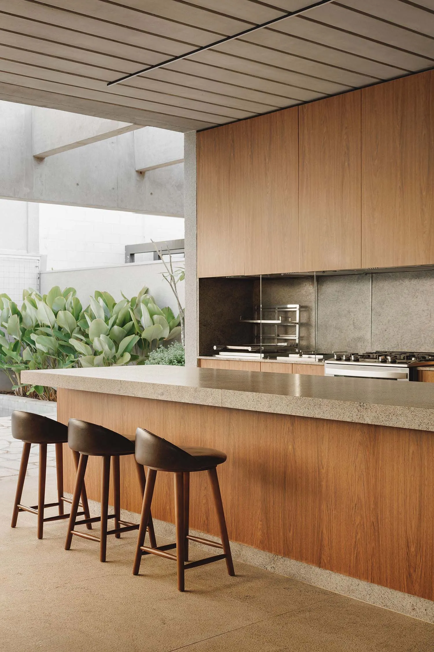 A modern kitchen featuring a concrete and wood design