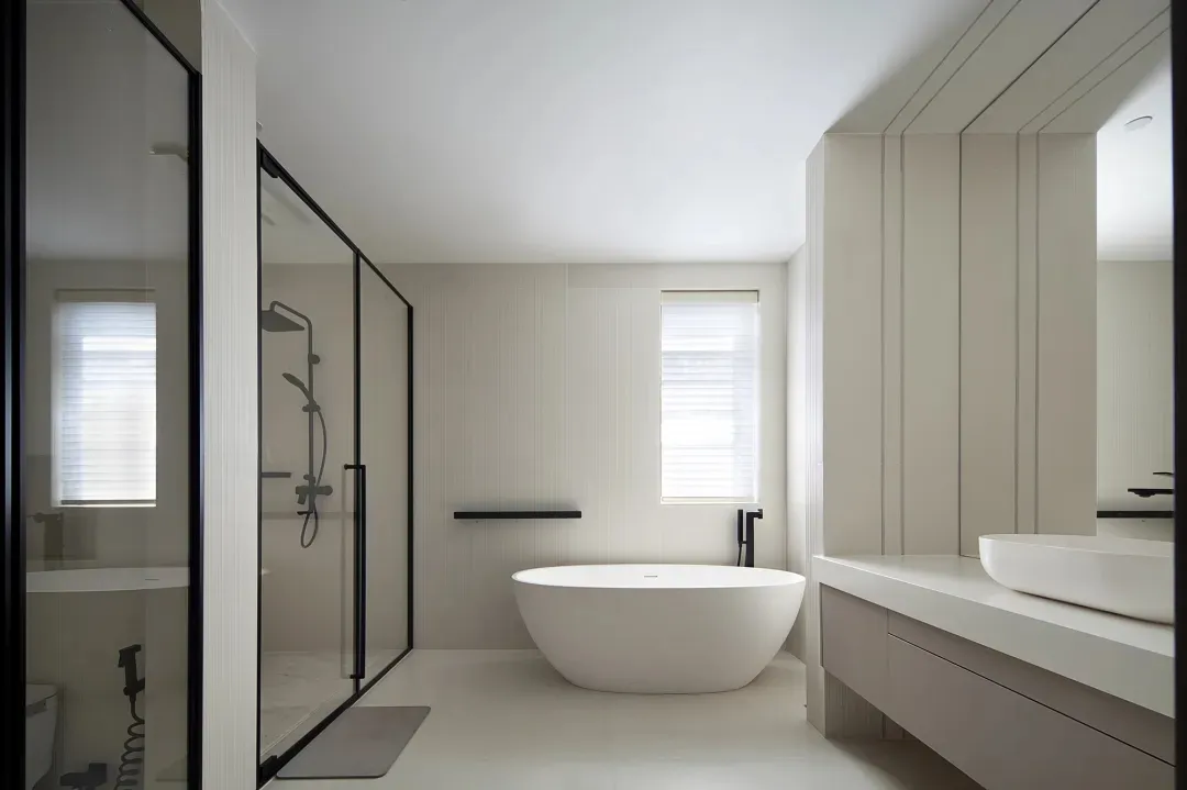 Modern, minimalist bathroom featuring white ceramics and sleek, clean design.