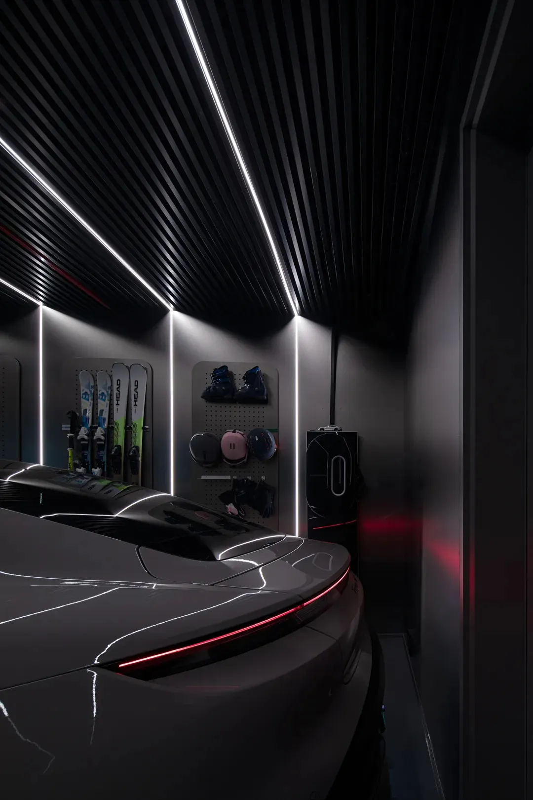 A sleek, modern garage interior with black metal walls and ceiling features.