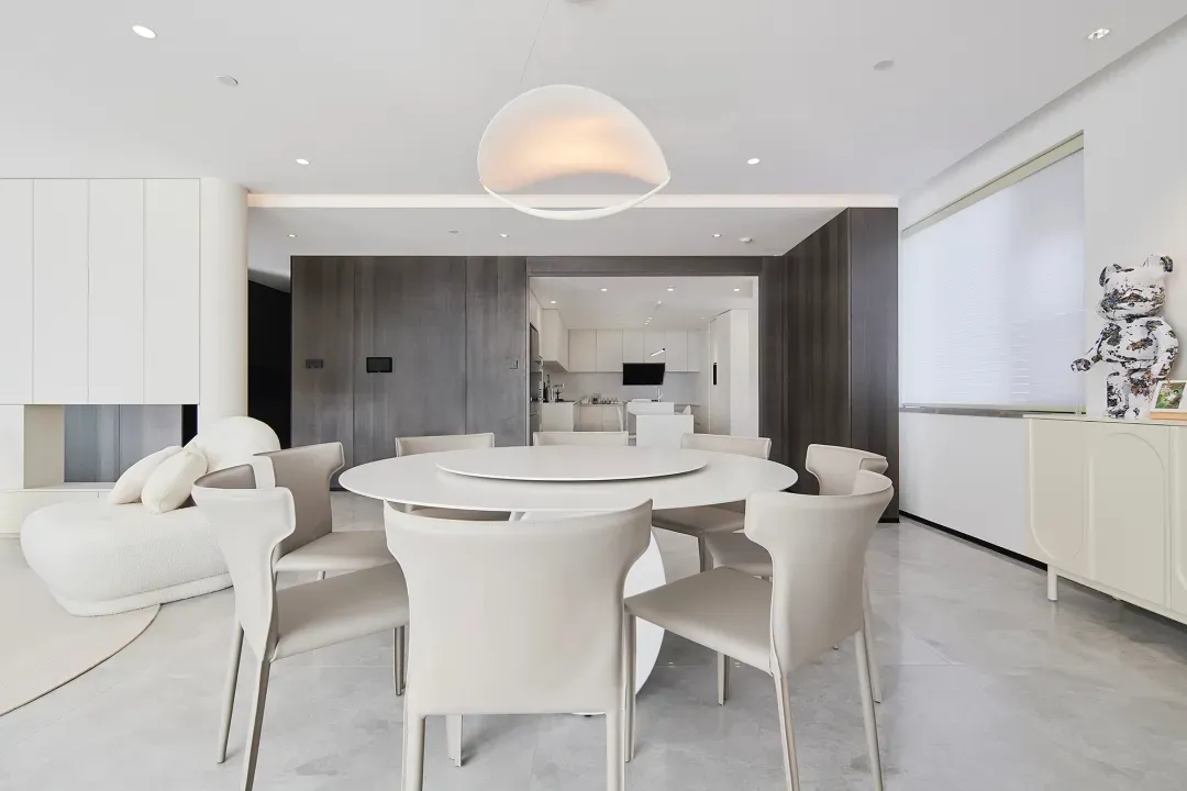 Modern interior living room featuring a white marble dining table and chairs