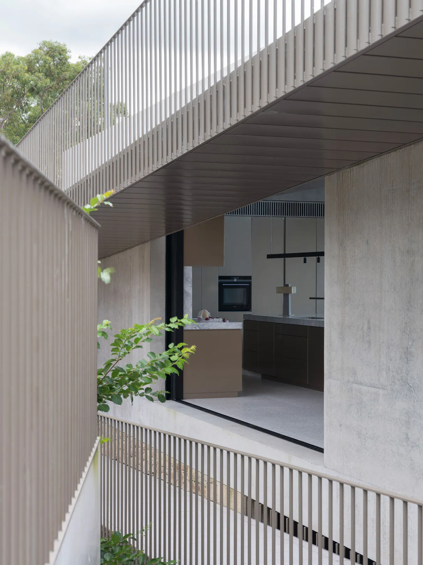Modern kitchen interior with concrete elements and minimalist design.