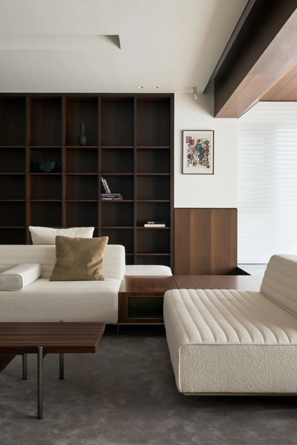 Modern living room featuring wooden furniture and a large bookshelf.
