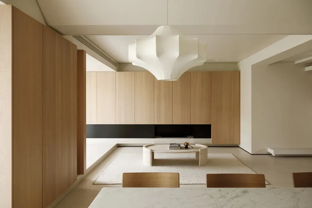 Modern minimalist living room with wooden furniture and marble accents