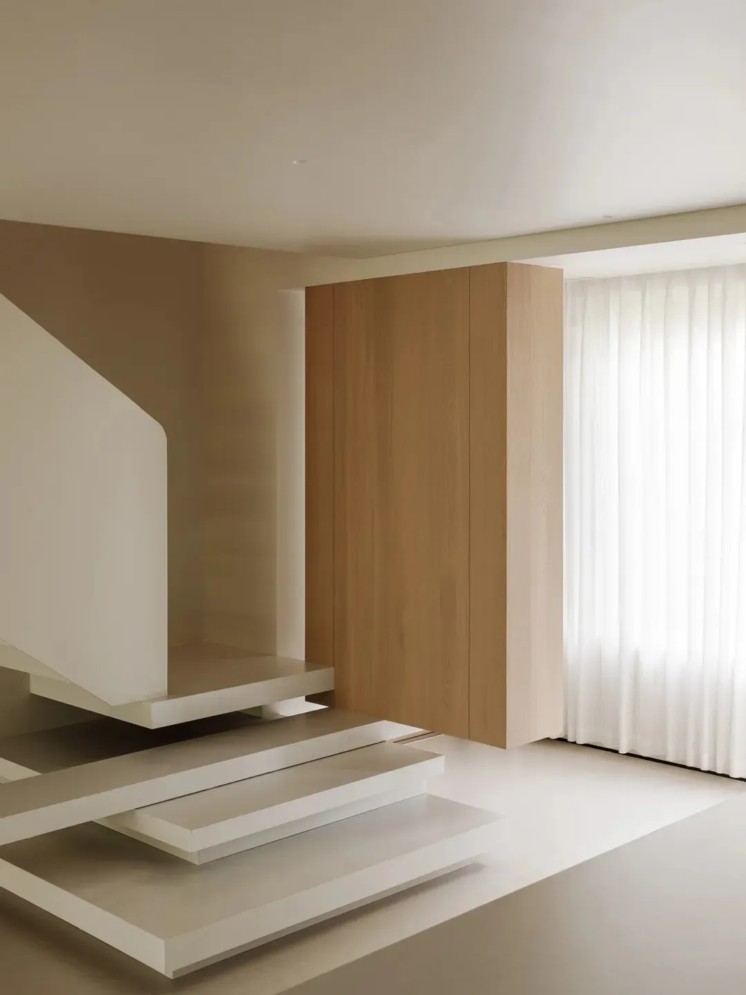 Modern, minimalist staircase with concrete steps and railings.