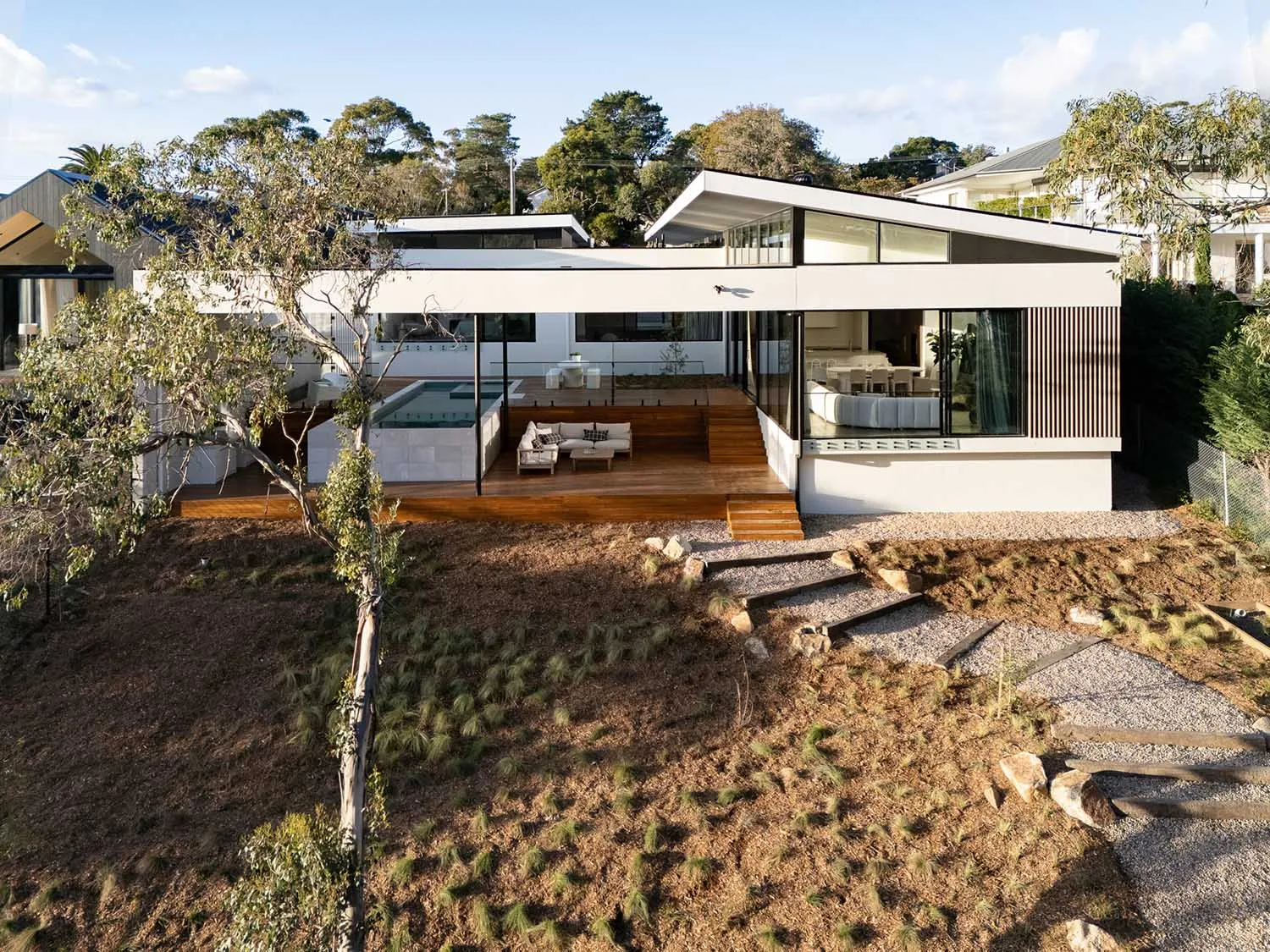 A modern house with wood, glass, and metal exterior features.