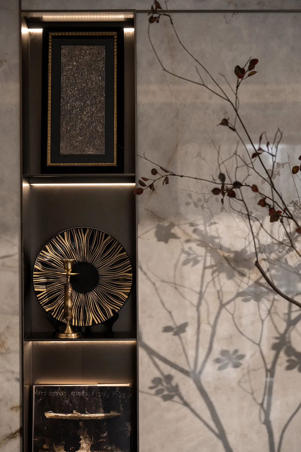 Modern interior design featuring a decorative glass pane with intricate gold patterns.