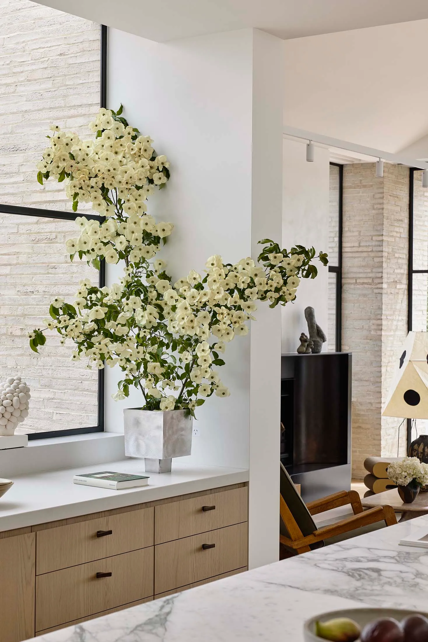 Modern interior space featuring minimalist design, marble countertops, and white brick walls.